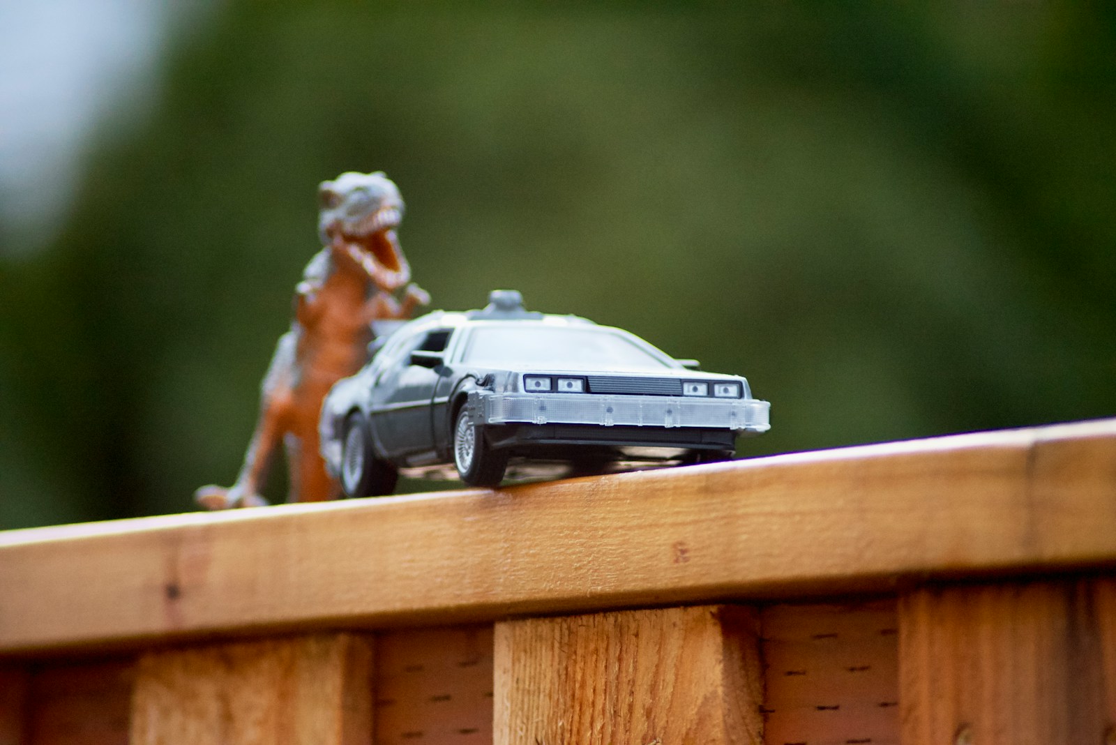 a toy car is on a wooden rail